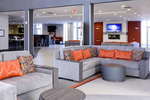 a living room with two couches and a table at Holiday Inn Abilene - North College Area, an IHG Hotel in Abilene