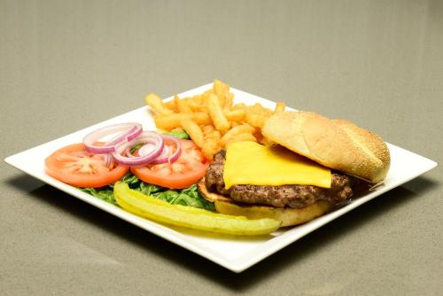 a white plate with a hamburger and french fries at Holiday Inn Abilene - North College Area by IHG in Abilene
