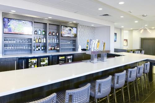 a bar with chairs and a counter with wine bottles at Holiday Inn Abilene - North College Area by IHG in Abilene