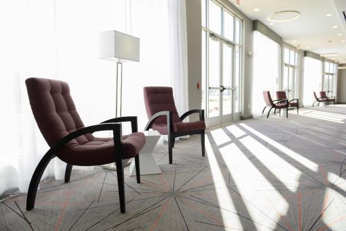 a waiting room with chairs and a table in a building at Holiday Inn Abilene - North College Area by IHG in Abilene
