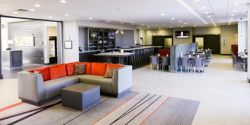 a lobby with a couch and a bar at Holiday Inn Abilene - North College Area, an IHG Hotel in Abilene
