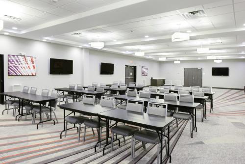 a classroom with tables and chairs in a room at Holiday Inn Abilene - North College Area by IHG in Abilene