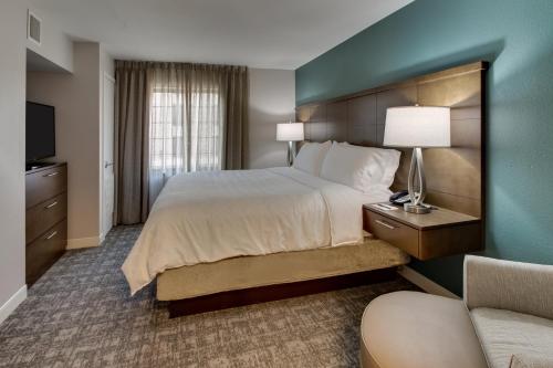 a hotel room with a bed and a couch at Staybridge Suites Missoula by IHG in Missoula
