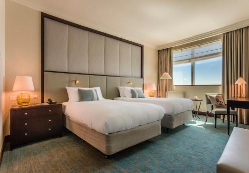 a hotel room with two beds and a large window at InterContinental Warszawa by IHG in Warsaw