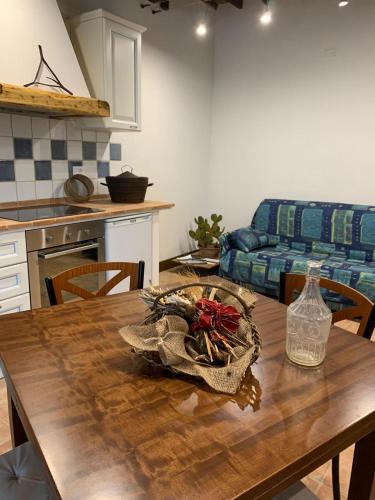 a kitchen and dining room with a wooden table at Casa vacanza vicolo degli orti in Monticiano