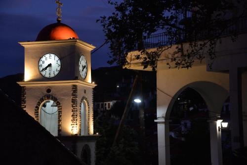 a clock tower with a orange ball on top of it at The fig tree house in Samothráki
