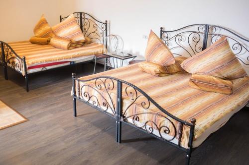two metal beds with pillows on them in a room at Motel Aris Meridian in Piatra Neamţ