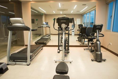 a gym with several exercise bikes and treadmills at Holiday Inn Cúcuta by IHG in Cúcuta