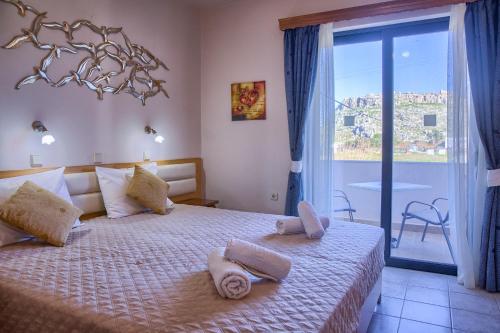 a bedroom with a bed with towels on it at Davinci's Studios in Haraki