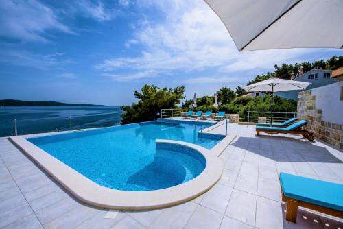 a swimming pool with a view of the water at Hotel Skalinada in Zavala