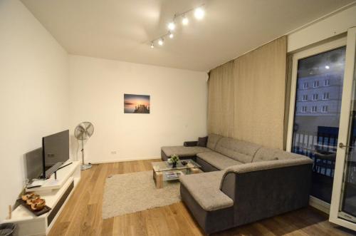 a living room with a couch and a television at 2 · High-Quality in the heart of Stuttgart 2 in Stuttgart