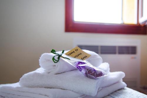 a pile of towels with a soap on top at Sant'Andrea Agriturismo con cantina Martignago Vignaioli Asolo Prosecco Docg Wines in Maser
