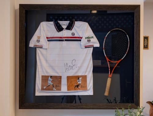 a picture of a shirt and a tennis racket at Pensiunea Sibiel in Sibiel
