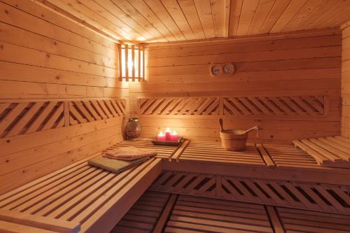 a wooden sauna with a candle in it at Pensiunea Sibiel in Sibiel