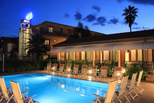 a swimming pool with chairs and a hotel at Hotel Residence La Darsena in Agropoli