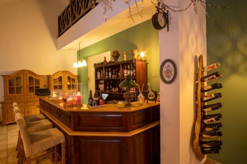 a kitchen with a bar with a wine rack at Pensiunea Sibiel in Sibiel