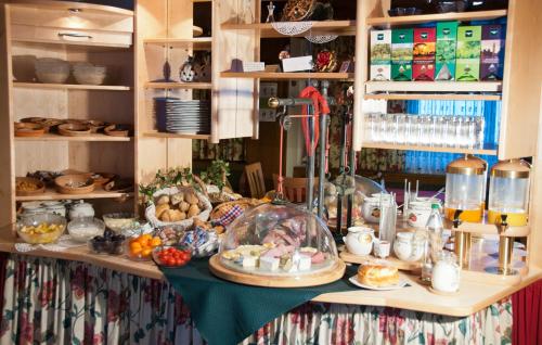 a table with food and other items on it at Pension Gertraud in Bad Kleinkirchheim