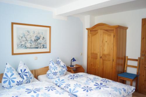 a bedroom with two beds with blue and white pillows at Ferienwohnung Kunkel in Kreuzau