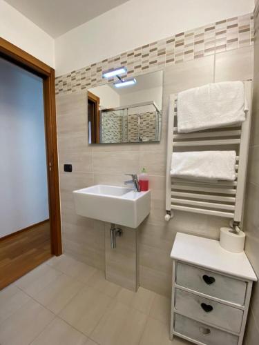 a bathroom with a sink and a mirror at Suite Mavino Appartamenti in Sirmione