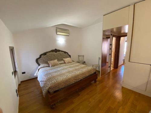 a bedroom with a bed and a wooden floor at Suite Mavino Appartamenti in Sirmione