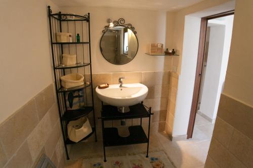 a bathroom with a sink and a mirror at Trullo Dell’Antica Fileria in Alberobello