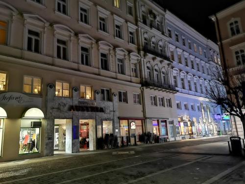 an empty street in front of a building at night at Oranges Apartment in Gmunden