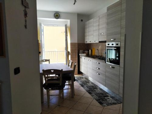 a kitchen with a table and a dining room at Casa vacanze GALA in Fiumicino