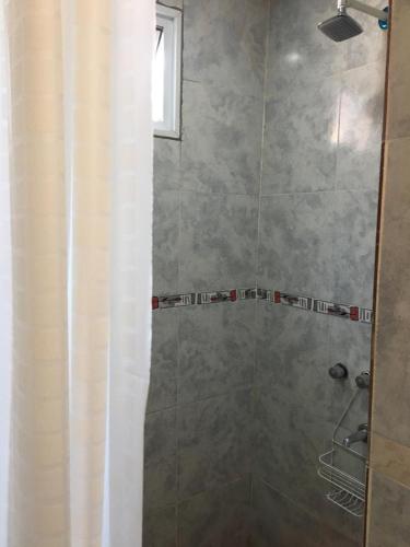 a bathroom with a shower with a shower curtain at Ventanas al sur 2 in San Nicolás de los Arroyos