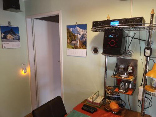 a room with a table with a radio on a shelf at Oranges Apartment in Gmunden