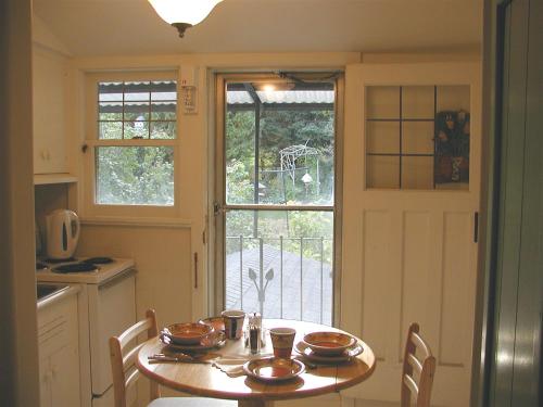 a kitchen with a table and a window at Burley's Executive Garden Suite in Peterborough