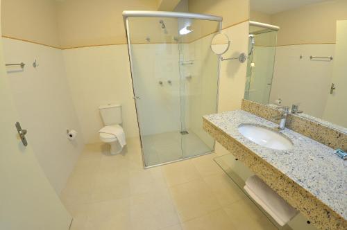 a bathroom with a shower and a sink and a toilet at Rothenburg Hotel in Nova Petrópolis