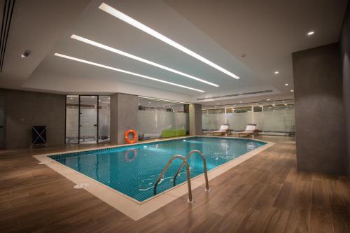 a swimming pool in a large room with a large at Executives Hotel - Olaya in Riyadh