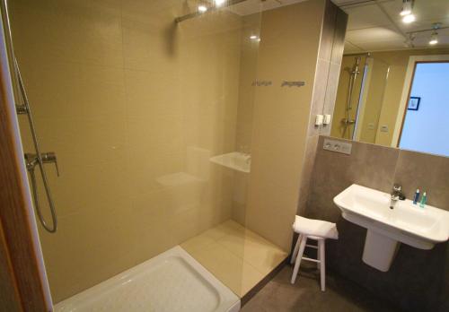 a bathroom with a shower and a sink and a toilet at Hostal Fornet Altea in Altea