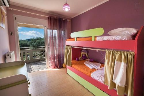 a bedroom with two bunk beds with a window at VILLA FAIRIES in Lygia