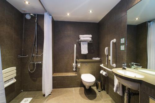 a bathroom with a toilet and a sink and a shower at Holiday Inn Aberdeen West by IHG in Westhill 