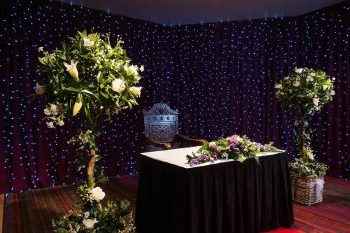 a table with flowers on it in a room at Holiday Inn Aberdeen West by IHG in Westhill 