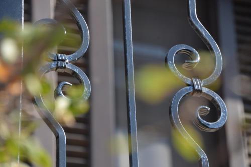 a wrought iron fence with raindrops on it at The fig tree house in Samothráki