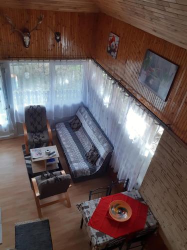 a living room with a couch and a table at Diófa Kuckó Apartman in Zalakaros