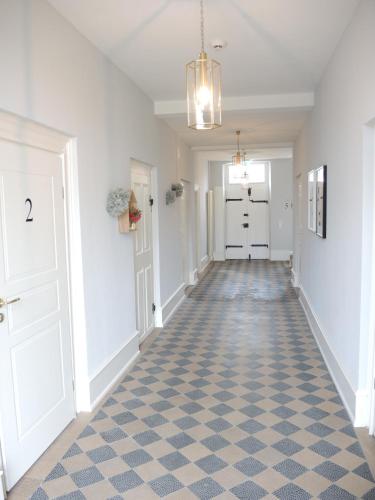 a hallway of a home with a checkered floor at Netts Landhaus in Neustadt an der Weinstraße