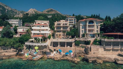 an aerial view of a resort with people in the water at Vila Fortuna in Sutomore