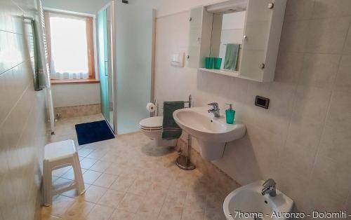 a bathroom with a sink and a toilet at 7home in Auronzo di Cadore