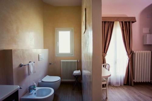 a bathroom with a toilet and a sink at Boutique Hotel Casa Faccioli in Bologna