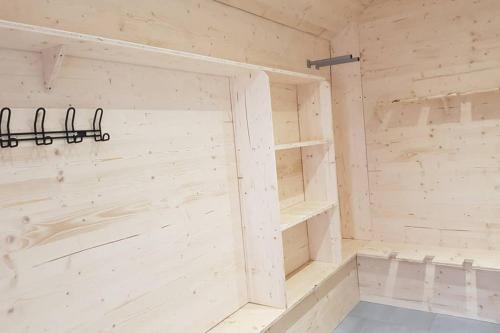 a wooden sauna with two shelves and a door at Le Skating Autrans in Autrans