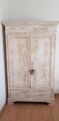 a wooden cabinet in the corner of a room at Sweet Home in Falconara Marittima