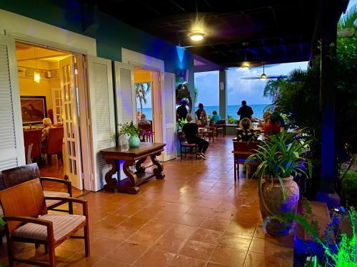 a porch of a restaurant with people sitting at tables at Blue Horizon Boutique Resort in Vieques