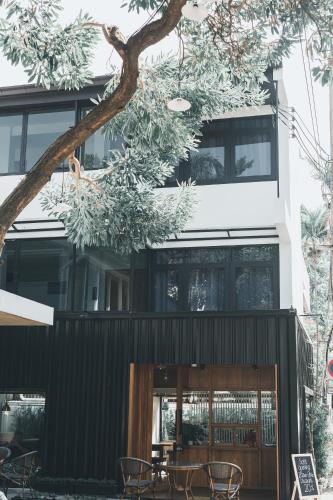 a building with a table and chairs in front of it at 41Cafetel in Bangkok