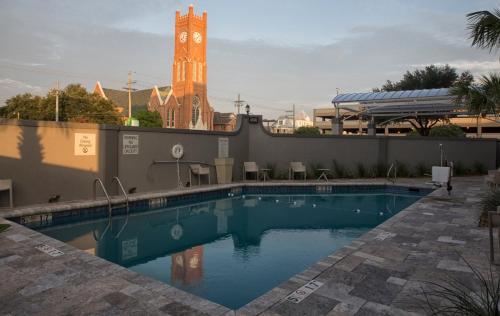a large swimming pool with a clock tower in the background at Holiday Inn Alexandria - Downtown, an IHG Hotel in Alexandria