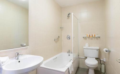 a white bathroom with a sink and a toilet at Ariel House in Dublin