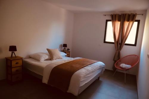 een slaapkamer met een bed en een raam bij Très bel appartement avec grande terrasse in Porto-Vecchio