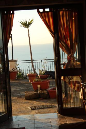 an open door with a view of the ocean at Villa Malandrino Guest House in Agropoli